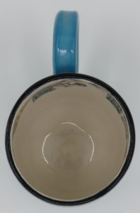 The Outside is Turquoise on the bottom and Pansy Blue on top. The inside is white and has a prayer flag design. Mug Measures approx. 4" tall x 5 1/2" wide to edge of handle and approx. 3 1/4" in diameter.