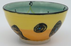 This bowl is a good size for serving small portions of things. It measures approximately, 5" in diameter x 2 3/4" tall. The outside is Tangerine on the bottom and Buttercup on the top. It has a random abstract black line drawing design with turquoise accents. The inside is Sea Grass on Top and Red on the bottom and has an open flower and more abstract line drawings.