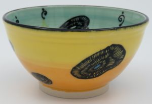 This bowl is a good size for serving small portions of things. It measures approximately, 5" in diameter x 2 3/4" tall. The outside is Tangerine on the bottom and Buttercup on the top. It has a random abstract black line drawing design with turquoise accents. The inside is Sea Grass on Top and Red on the bottom and has an open flower and more abstract line drawings.